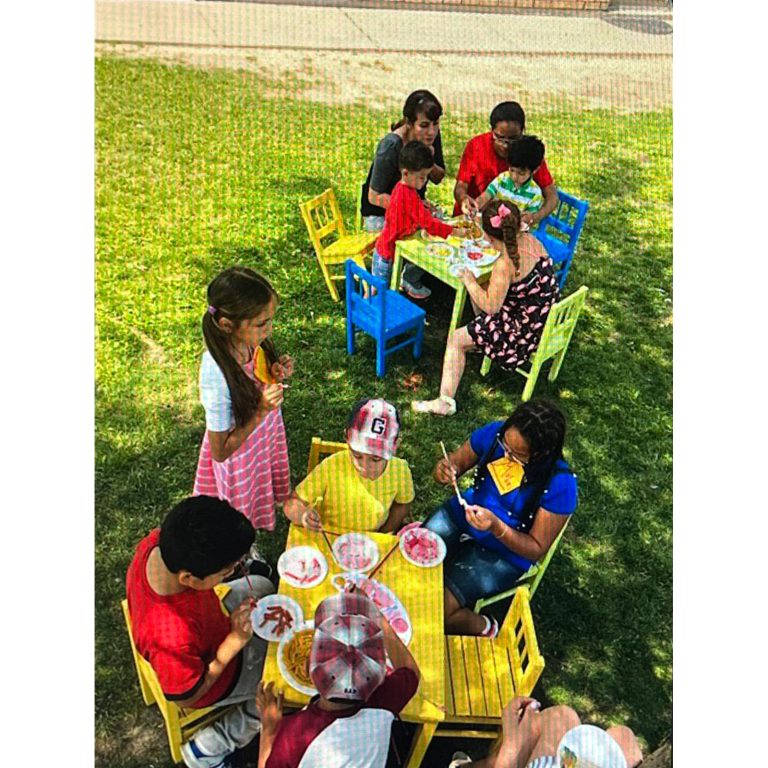 Families and children taking part in an outdoor creative activity