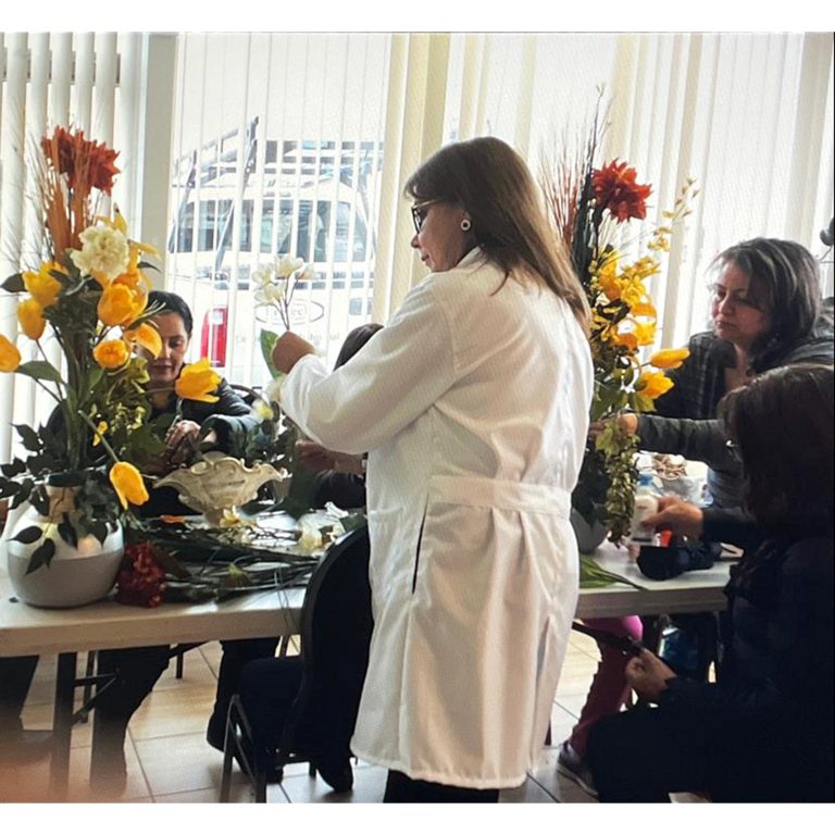 Participants creating floral arrangements in a hands-on workshop