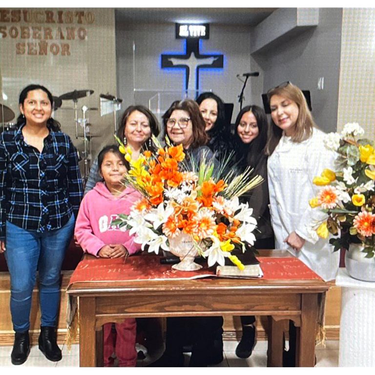 Participants presenting completed floral arrangements