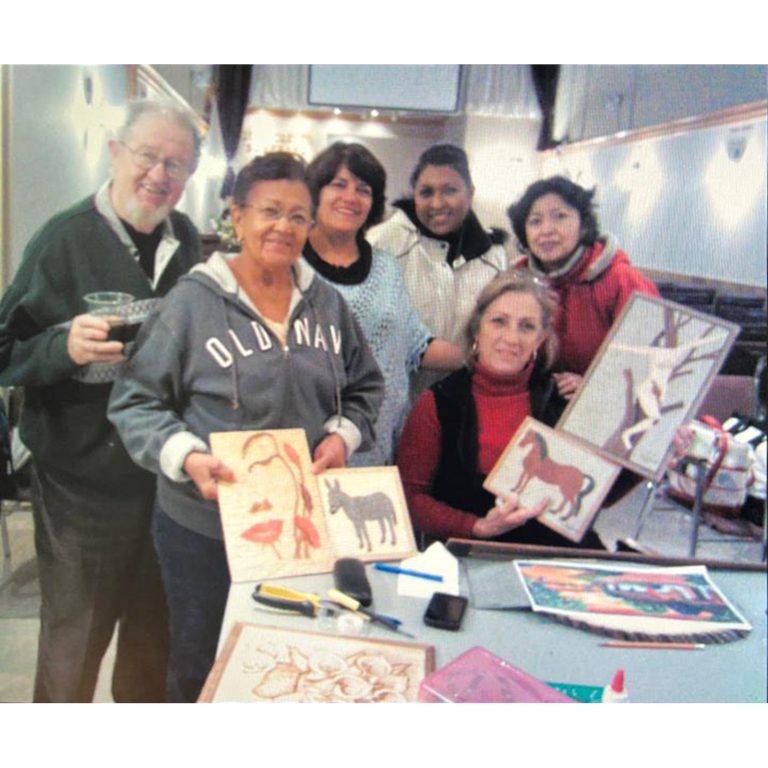 Participants displaying artwork completed in an AGAPE arts activity
